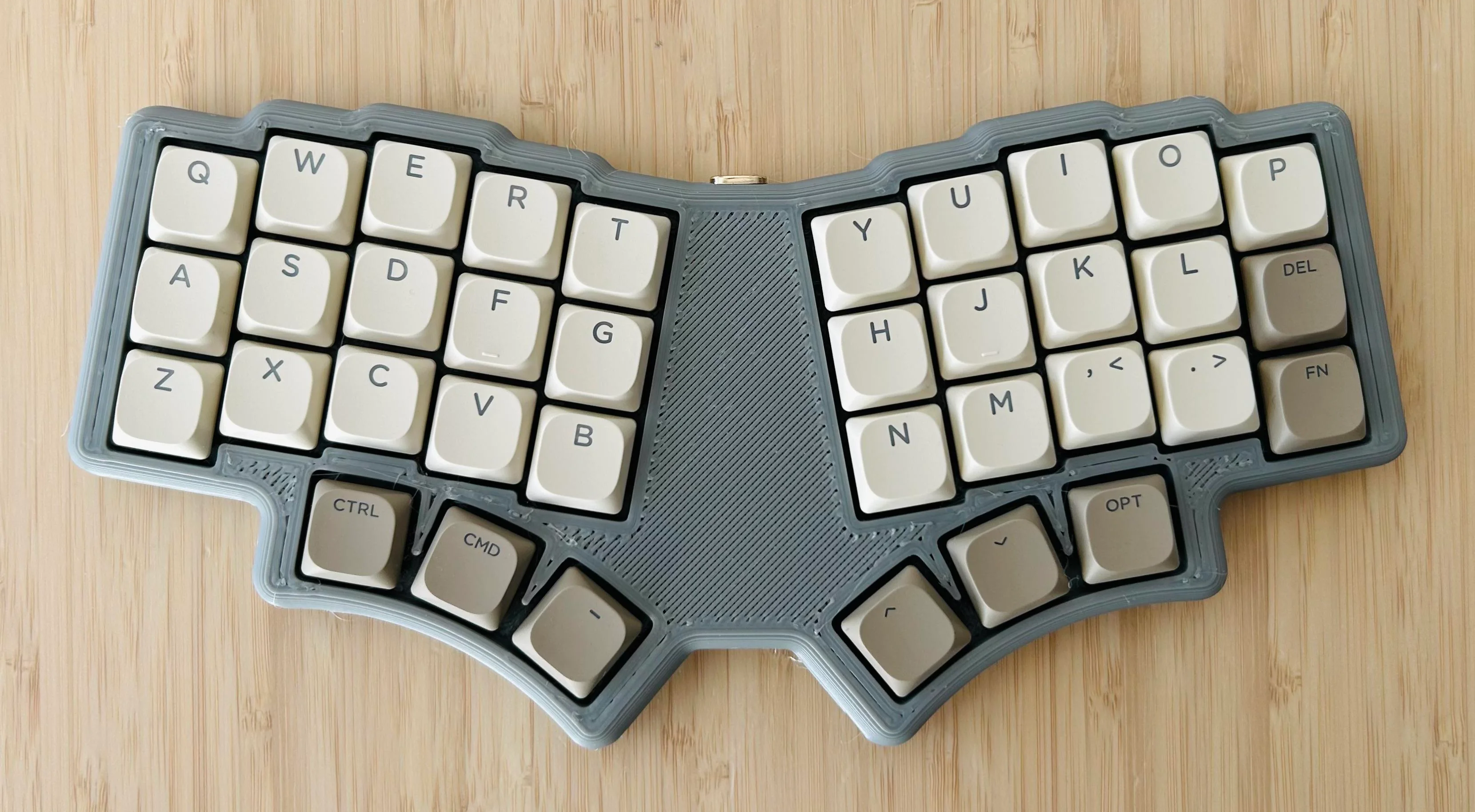 A 36-key monoblock split keyboard with three thumb keys on each side.