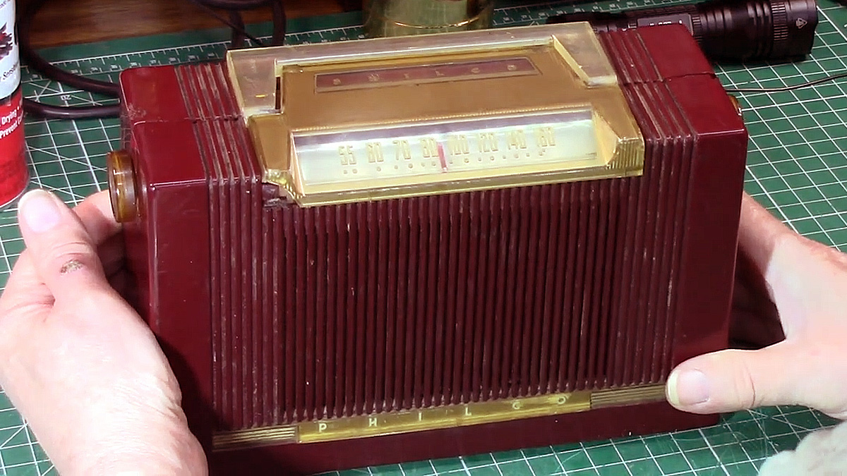 Red and gold bakelite Philco farm radio on a workbench